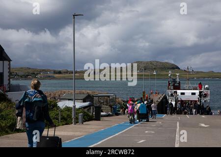 Ferry passengers queuing for the foot-ferry to Iona from Fionnphort, Isle of Mull. Stock Photo