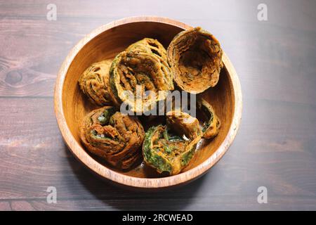 Dry Patra is an Indian dish made with colocasia leaves that are coated with a spicy gram flour batter and deep fried. It's a popular dish in Gujarat. Stock Photo