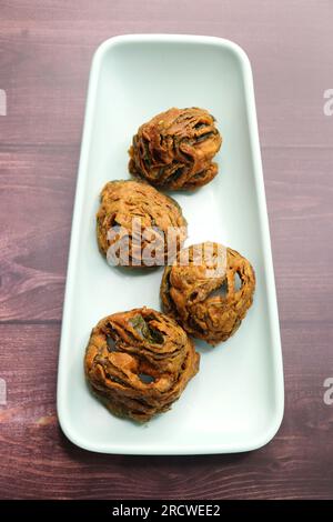 Dry Patra is an Indian dish made with colocasia leaves that are coated with a spicy gram flour batter and deep fried. It's a popular dish in Gujarat. Stock Photo