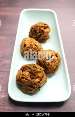 Dry Patra is an Indian dish made with colocasia leaves that are coated with a spicy gram flour batter and deep fried. It's a popular dish in Gujarat. Stock Photo