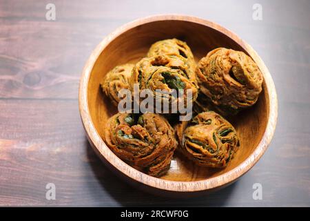 Dry Patra is an Indian dish made with colocasia leaves that are coated with a spicy gram flour batter and deep fried. It's a popular dish in Gujarat. Stock Photo