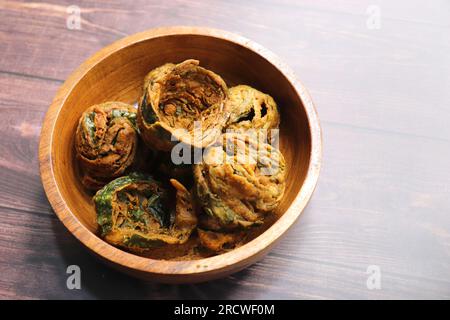 Dry Patra is an Indian dish made with colocasia leaves that are coated with a spicy gram flour batter and deep fried. It's a popular dish in Gujarat. Stock Photo