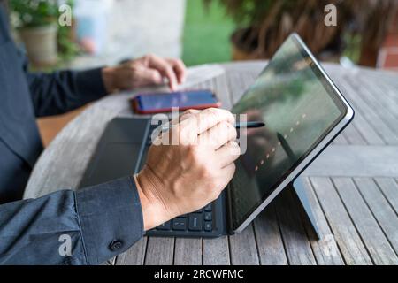 Businessman working on his tablet by using his stylus pen. Home environment. Stock Photo