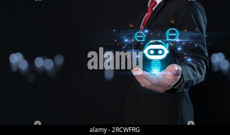 Businessman holding hologram digital chatbot, robot application, conversation assistant, AI Artificial Intelligence concept, digital chatbot on virtua Stock Photo