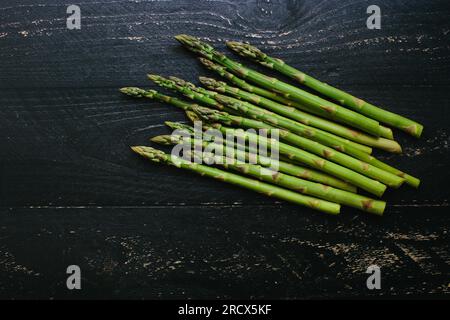 Bunch of fresh picked asparagus on a dark rustic wood table Stock Photo