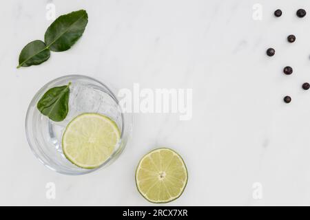 Gin tonic cocktail drink in glass on white marble background Stock Photo