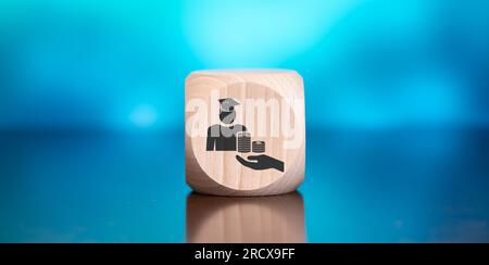 Wooden block with symbol of fafsa concept on blue background Stock Photo