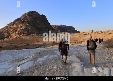 Walkers in the landscape of the Beidha valley before Little Petra, Al-Sharat area of Jordan, Middle East Stock Photo