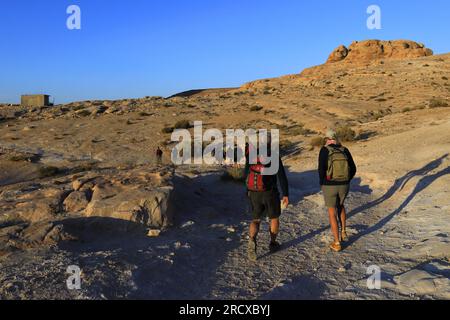 Walkers in the landscape of the Beidha valley before Little Petra, Al-Sharat area of Jordan, Middle East Stock Photo