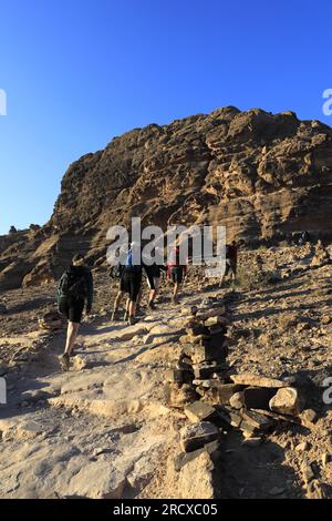 Walkers in the landscape of the Beidha valley before Little Petra, Al-Sharat area of Jordan, Middle East Stock Photo