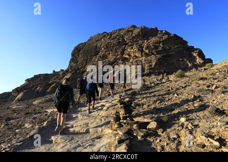 Walkers in the landscape of the Beidha valley before Little Petra, Al-Sharat area of Jordan, Middle East Stock Photo