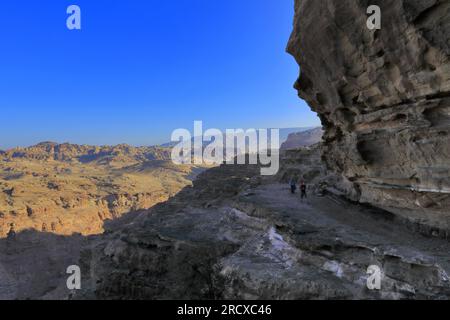 Walkers in the landscape of the Beidha valley before Little Petra, Al-Sharat area of Jordan, Middle East Stock Photo