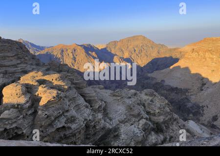 Walkers in the landscape of the Beidha valley before Little Petra, Al-Sharat area of Jordan, Middle East Stock Photo