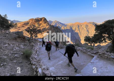 Walkers in the landscape of the Beidha valley before Little Petra, Al-Sharat area of Jordan, Middle East Stock Photo