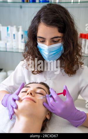 Female during the procedure of botulinum toxin against hyperhidrosis in ...