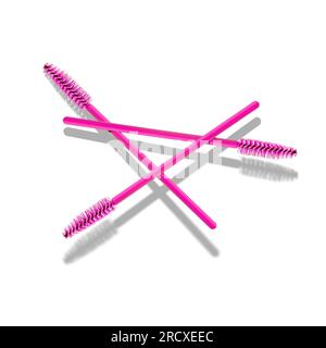 a group of three pink eyelash brushes, on a white solid background. Eyelash accessories Stock Photo