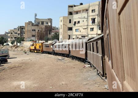 A train among houses - An old Turkish Ottoman steam train in Jordan - Hedjaz Jordan Railway Stock Photo