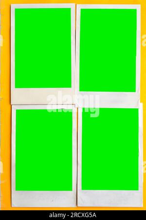 A vintage book page with four blank instant photo frames. Stock Photo