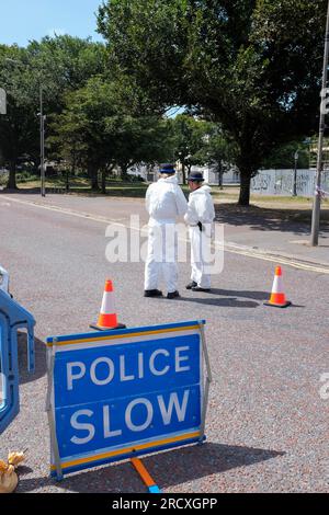 Brighton UK 17th July 2023 - Police and PCSO's wearing protective suits and masks because of the lingering smoke in the air as the streets are still closed around The Royal Albion Hotel in Brighton after the major fire over the weekend  : Credit Simon Dack / Alamy Live News Stock Photo