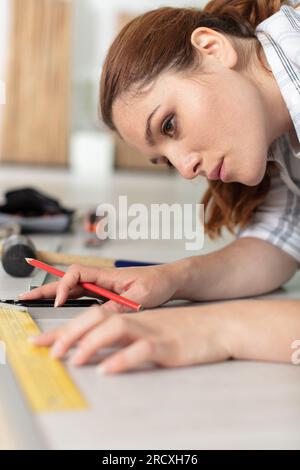 construction worker handyman installing new wood floor at house Stock Photo