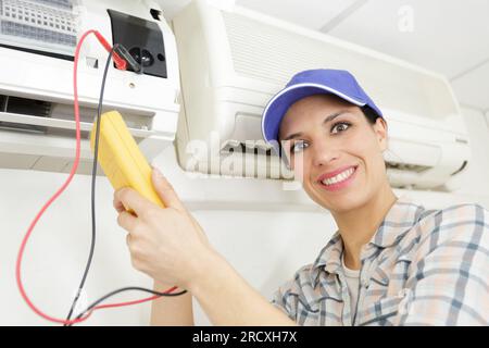 female electrician testing a c Stock Photo