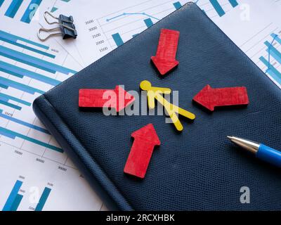 Customer focus concept. Figure with arrows and blue notepad on the papers. Stock Photo