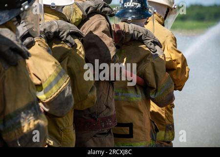 Firefighters and rescue training. Firefighter spraying high pressure water to fire Burning fire flame background Stock Photo