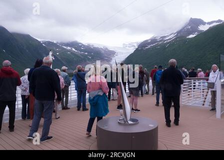 Cruise passengers on deck on cruise ship in Holandsfjord close to end of Engabreen glacier arm of Svartigen Norway Europe Stock Photo
