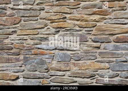 Retro stone wall texture. Natural stone wall background. Stock Photo