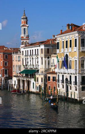 VENICE, ITALY - SEPTEMBER 16, 2009: Tourists ride a gondola boat in Canal Grande in Venice, Italy. Venice Old Town is a UNESCO World Heritage Site. Stock Photo