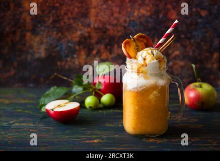 Apple cider float with caramel sauce and stick of cinnamon Stock Photo