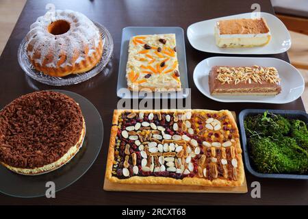 Easter cakes table in Poland. Easter pastry: babka cake, mazurek cakes and cheesecakes. Easter in Poland - Wielkanoc. Stock Photo
