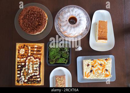 Easter cakes table in Poland. Easter pastry: babka cake, mazurek cakes and cheesecakes. Easter in Poland - Wielkanoc. Stock Photo
