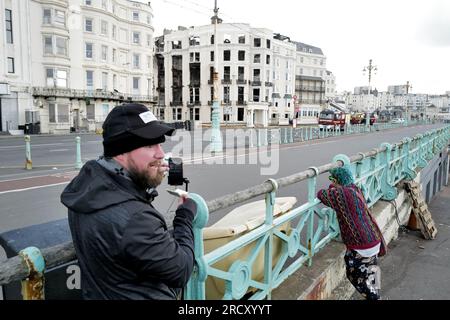 Brighton, UK. 17th July, 2023. A Vlogger steams live coverage from outside the destroyed Royal Albion Hotel. Credit: James Boardman/Alamy Live News Stock Photo