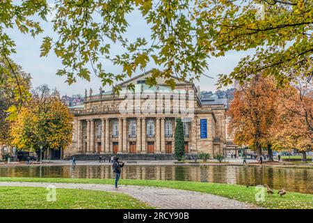 Autumn in Germany, Stuttgart downtown with yellow leaves on the trees by the historical Staatstheater (state theatre) and Oberer Schlossgarten park Stock Photo