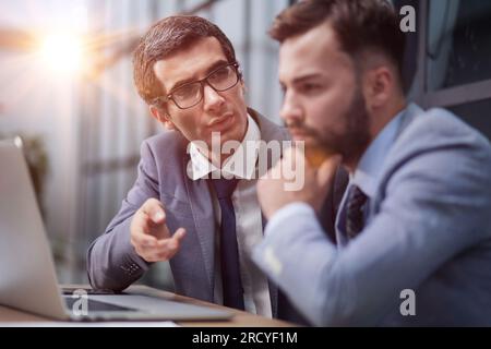colleagues talking, working on project together in the office Stock Photo