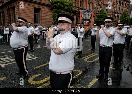 Members of the Shankill Protestant Boys band march through Belfast City centre as part of the annual July 12th parade season. July marks the annual loyalist marching season as practiced by the Protestant unionist communities of Northern Ireland in commemoration of a centuries-old military victory of Protestant King William of Orange over Catholic King James the second. The season culminates with a day of parades throughout the North on the 12th of July following the Eleventh Night bonfire celebrations the previous night. Stock Photo