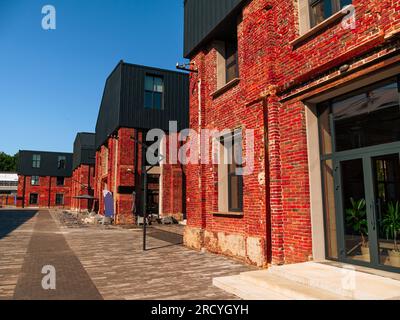 Modern cafe workspace exterior loft style red brick wall Old industrial building renovation. Creative urban space Break-out area city loft conversion Stock Photo