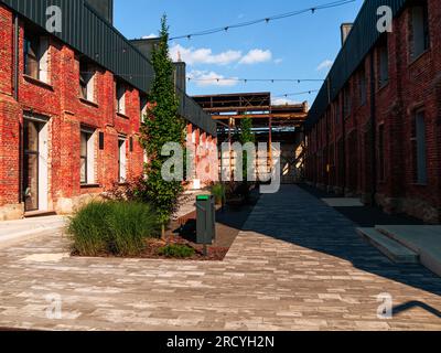 Modern cafe workspace exterior loft style red brick wall Old industrial building renovation. Creative urban space Break-out area city loft conversion Stock Photo