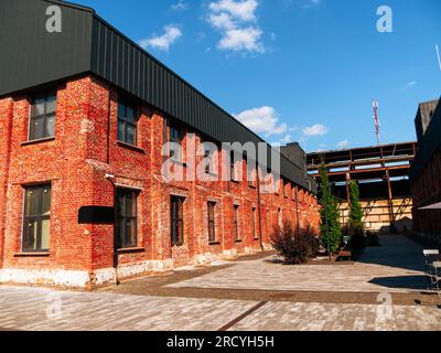 Modern cafe workspace exterior loft style red brick wall Old industrial building renovation. Creative urban space Break-out area city loft conversion Stock Photo