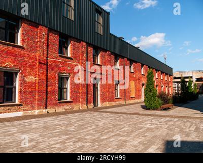 Modern cafe workspace exterior loft style red brick wall Old industrial building renovation. Creative urban space Break-out area city loft conversion Stock Photo