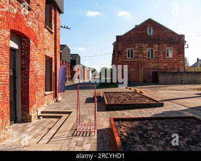 Modern cafe workspace exterior loft style red brick wall Old industrial building renovation. Creative urban space Break-out area city loft conversion Stock Photo