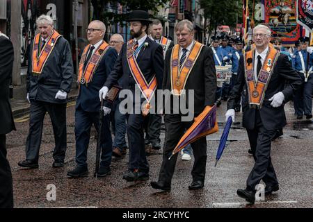 July 12, 2023, Belfast, Ireland: A group of Orangemen march through Belfast City centre as part of the annual July 12th parade season. July marks the annual loyalist marching season as practiced by the Protestant unionist communities of Northern Ireland in commemoration of a centuries-old military victory of Protestant King William of Orange over Catholic King James the second. The season culminates with a day of parades throughout the North on the 12th of July following the Eleventh Night bonfire celebrations the previous night. (Credit Image: © Graham Martin/SOPA Images via ZUMA Press Wire) Stock Photo