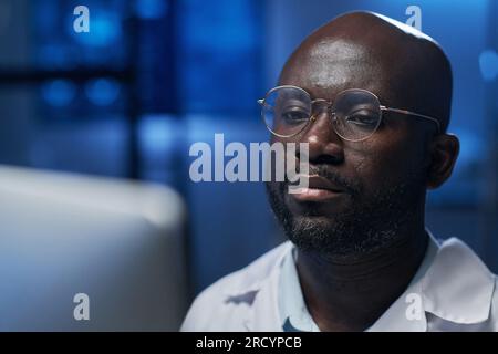 African American engineer in eyeglasses working on computer in the lab Stock Photo