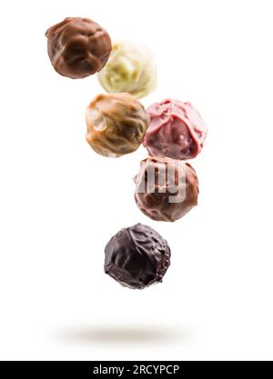 Assorted chocolate pralines floating on white background Stock Photo