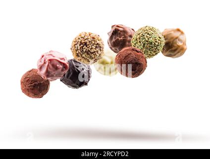 Assorted chocolate pralines floating on white background Stock Photo