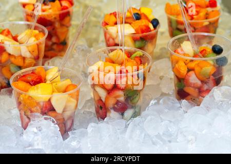 Fresh Fruit Salad Arranged in Plastic Cups for Sale Stock Photo