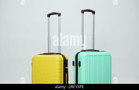 Two bright yellow and light green suitcases, isolated on white studio background with copy ad space. Luggage. Low cost. Air flight. Travel. Tourism. T Stock Photo