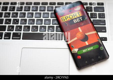 Sports Live streaming concept showing Soccer or football game broadcast on smartphone with laptop high tech background. Accessible on demand digital Stock Photo