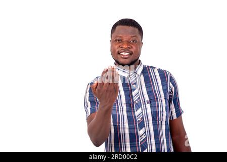 portrait of a satisfied handsome young man inviting to come over while smiling at the camera. Stock Photo